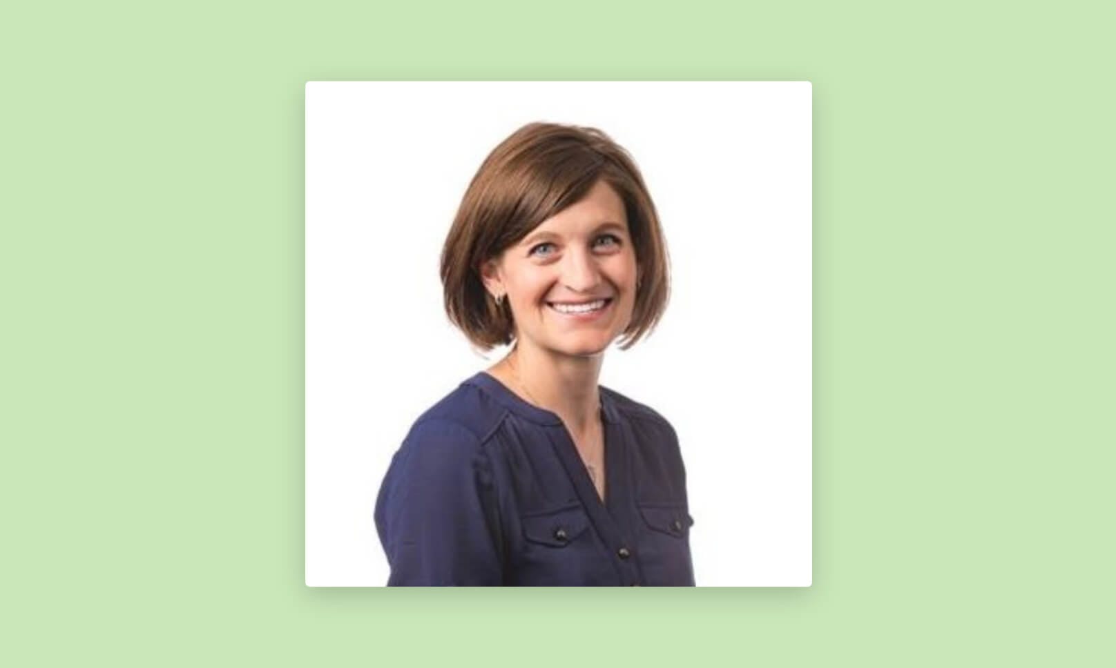 A headshot of Dr. Karen Landmeier against a green background.